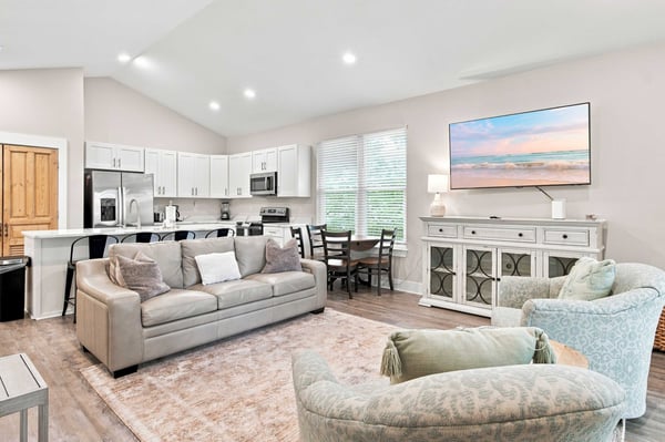 Unwind in your open-concept living space, where plush seating and a fully equipped kitchen await. Natural light pours through the windows, illuminating a perfect retreat for relaxation and connection.